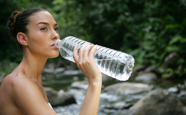 Woman drinking from water bottle